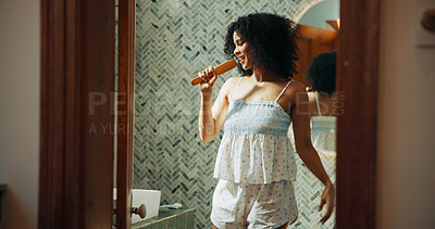 Buy stock photo Woman, brush and singing with smile in bathroom for playful, concert and voice for sound and morning in home. African person, hair care and happy with karaoke, song and funny performance at apartment