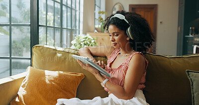 Buy stock photo Tablet, headphones and woman in home for music, streaming song and audiobook online. Living room, technology and African person listening to radio, podcast and sound for playlist on internet to relax