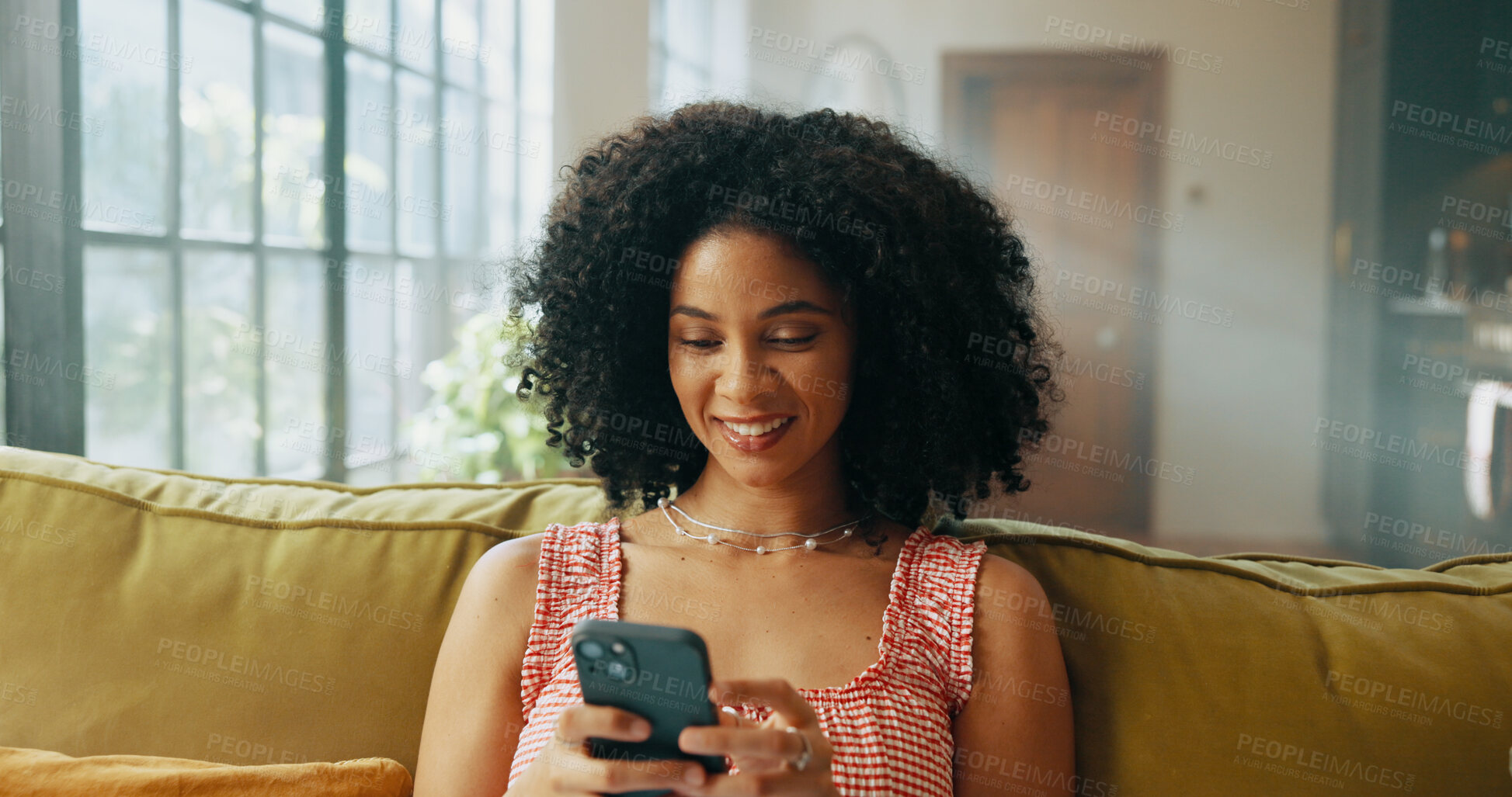 Buy stock photo Happy, phone and African woman on sofa in home for social media, networking and communication. Apartment, living room and person on smartphone for online chatting, internet post or website on weekend
