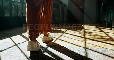 Buy stock photo Legs, walking and person with shoes in home for fashion, back view and shadow with footwear in hallway. Cool sneakers, feet and wood floor with steps for travel, journey or leave by corridor in house