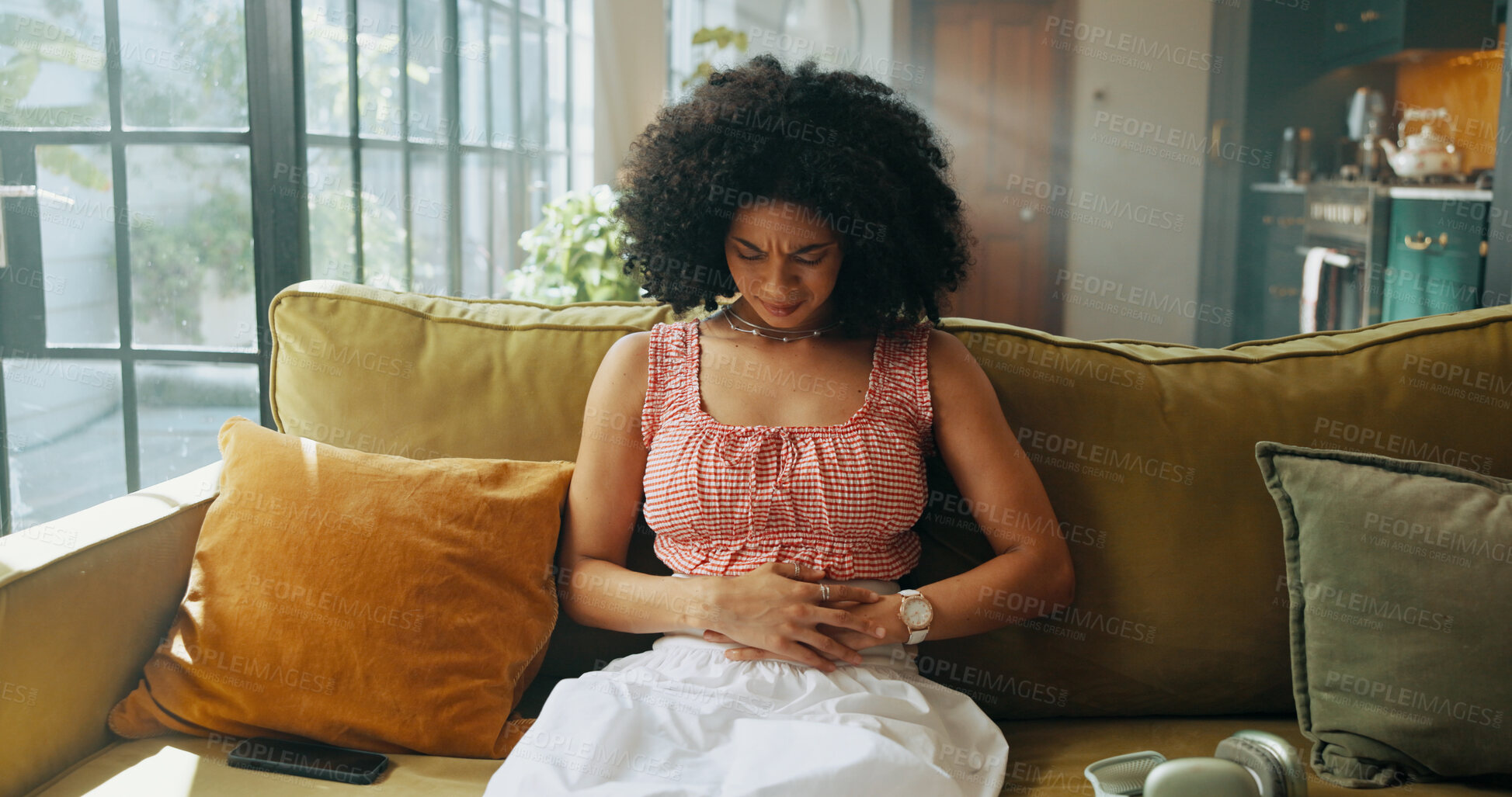 Buy stock photo Woman, pain and sofa with stomach ache for indigestion, gastrointestinal disease or reflux at home. Sick, female person or belly cramp with nausea, illness or menstruation for period cycle at house