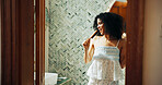 Woman, brush and singing with humor in bathroom for playful, concert and voice for morning routine in home. African person, hair care and happy with karaoke, song and funny performance at apartment