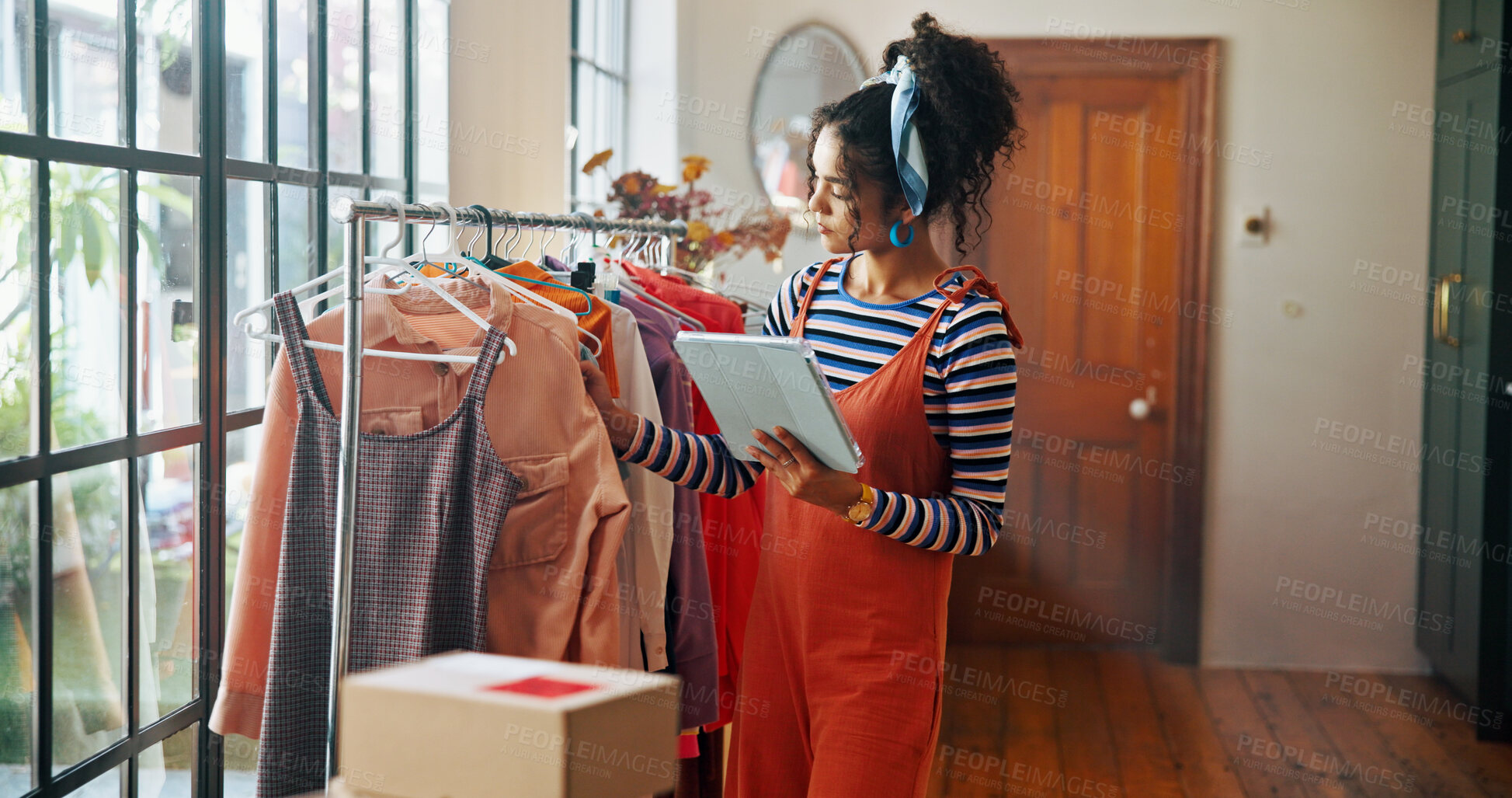 Buy stock photo Woman, tablet and clothes inspection of small business for stock check, quality control and checklist. Person, collection and digital for fashion ecommerce, inventory management and schedule delivery