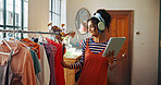 Woman, tablet and headphones for small business, ecommerce and fashion boutique startup with online sales. Designer, technology and website for internet store, retail service and quality control