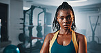 Portrait, fitness and serious black woman in gym for exercise, muscle or strength training for health. Determination, wellness and person at workout club with bodybuilder, confidence or challenge