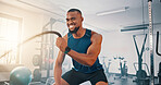 Gym, exercise and black man with battle rope for muscle growth, strength development and power workout. Equipment, endurance and African bodybuilder with resilience in fitness, challenge or hard work