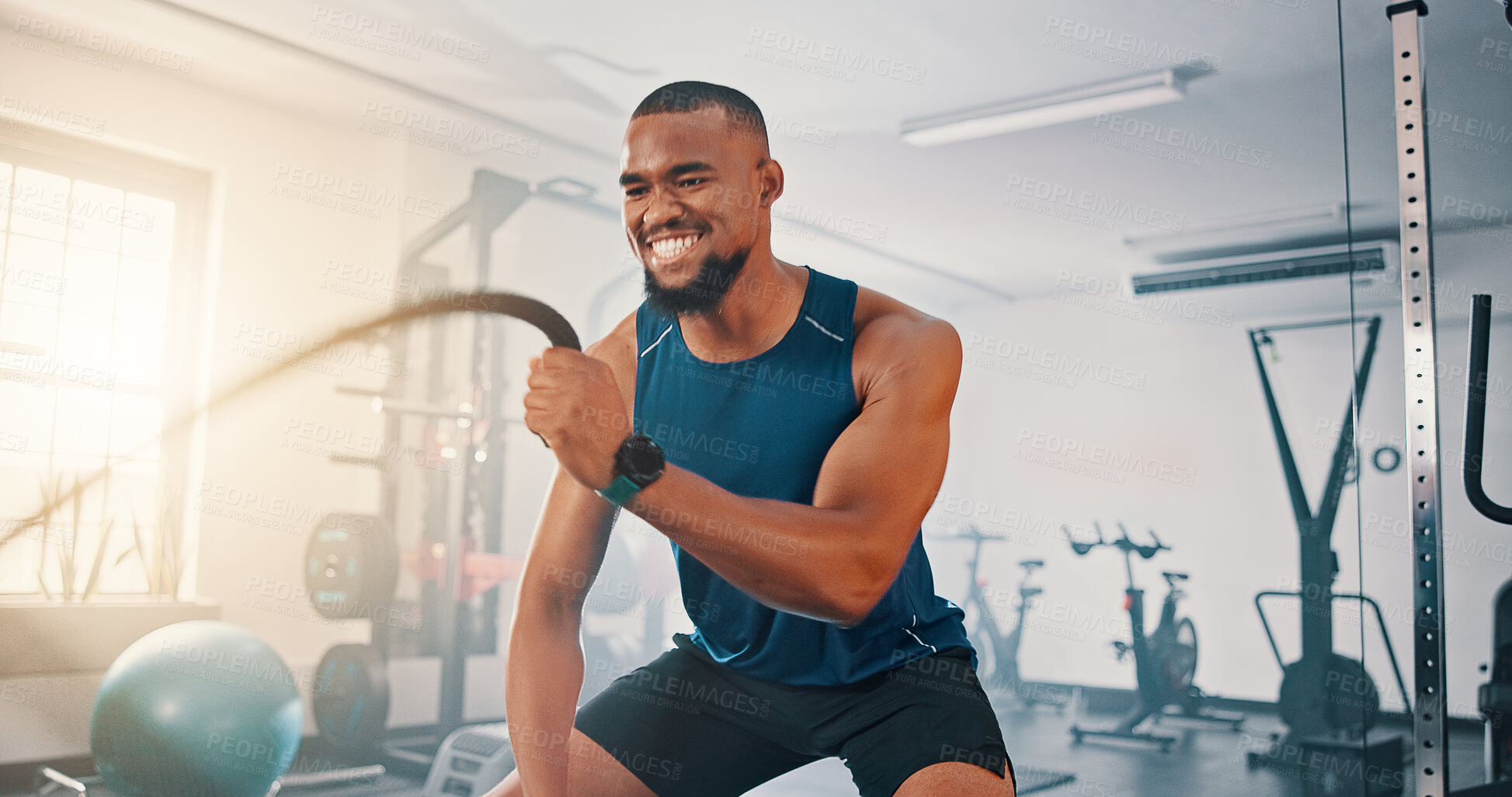 Buy stock photo Gym, exercise and black man with battle rope for muscle growth, strength development and power workout. Equipment, endurance and African bodybuilder with resilience in fitness, challenge or hard work