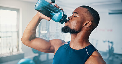 Buy stock photo Break, drinking water and fitness with man in gym for exercise, training or workout routine. Bottle, hydration and performance with athlete in health club for physical improvement or recovery