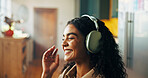 Headphones, relax and woman in house with remote work for creative magazine agency with project. Audio tech, happy and female critic editor streaming music, album or playlist for online review.