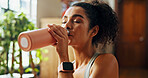 Home, woman and fitness with water to drink, hydration and nutrition for wellness after exercise. House, female person and workout break with liquid bottle for h2o, detox and thirsty in apartment