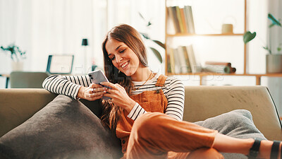 Buy stock photo Phone, smile and woman on sofa in home with networking, communication or contact on mobile app. Relax, cellphone and female person texting on social media for online conversation in living room.