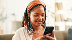 Smile, online and woman with mobile in home for social media, reading forum or ebook. African person, smartphone and relax on sofa with chat app for communication, text notification or download game