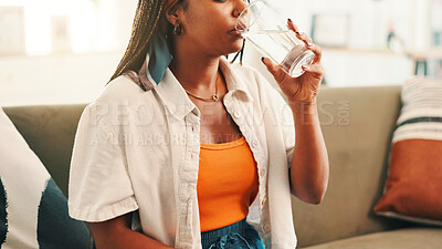 Buy stock photo Woman, hands and drink with water on sofa for hydration, medication or natural sustainability at home. Female person, aqua or mineral liquid for thirst, beverage or health and wellness at house
