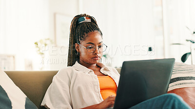 Buy stock photo Laptop, thinking and black woman typing on sofa, living room and search on social media. Computer, student and African person or writing email, research or online browsing on couch for university