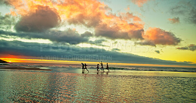 Buy stock photo Sunset, people running and friends at ocean for holiday, vacation and summer trip on island. Group, sea water and race by beach together for freedom, travel or energy for adventure at dusk with space
