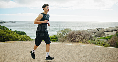 Buy stock photo Beach, running and man in street, fitness and training with cardio, energy and challenge. View, person and runner with exercise, outdoor and sports with wellness, practice and healthy with ocean