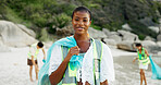 Portrait, recycling and waste with woman on beach for community service or conservation. Charity, earth and smile of happy volunteer outdoor on coast for activism, responsibility or sustainability