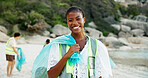 Portrait, recycling and smile of woman on beach for community service or conservation. Charity, earth and plastic bag with volunteer outdoor on coast for activism, responsibility or sustainability