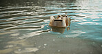 Paper, ocean and dirt with pollution for recycling, climate change or global warming in nature. Empty, sea or rubbish with container, litter or mess in water for waste management or contamination