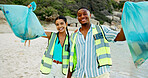 Happy people, portrait and volunteer with recycling on beach for community service or cleaning in nature. Man, woman or social workers with smile, bag or rubbish for climate change by ocean coast