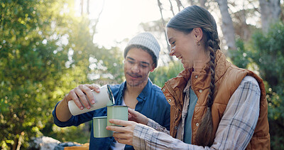 Buy stock photo Outdoor, camping and couple with coffee, forest and bonding with warm beverage in nature and adventure. Hiking, travel and people with hot tea for cold weather, traveller and tourists on vacation