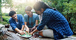 Map, nature and group of friends hiking in forest with route plan for adventure together. Travel, outdoor and people with paper guide for trekking in woods on weekend trip for discovery or journey.