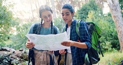 Buy stock photo Map, nature and girl friends hiking in forest with route plan for adventure together. Travel, outdoor and female people with paper guide for trekking in woods on weekend trip with backpacking.