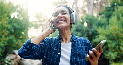 Buy stock photo Happy woman, headphones and phone for music in forest, travel or adventure with energy for playlist. Smartphone, radio and listening to song in nature park, audio streaming or relax with tech outdoor