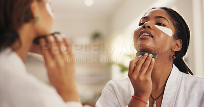 Buy stock photo Eye mask, massage and skincare with friends in home together for beauty or pampering. Aesthetic, facial transformation and gua sha with women in bathroom of apartment for dermatology routine