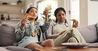 Buy stock photo Women, friends and watching tv with pizza, remote and channel surfing on sofa with choice for movie. Girl, people and relax with fast food, meal and discussion for film streaming decision in home