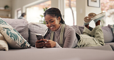Buy stock photo Home, relax and woman on sofa, cellphone and internet with smile, social media and funny meme. Apartment, mobile user or happy person on couch, smartphone or app for message to contact or online joke