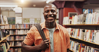 Buy stock photo African man, student and smile at library, portrait or excited for education, development or research at college. Person, happy and learning with pride, backpack or scholarship at university in Kenya