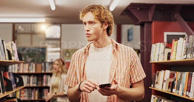 Buy stock photo Man, student and search with phone in library for education textbook, study material and knowledge. Male person, mobile and bookshelf at university with information, learning app and scholarship post