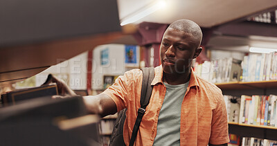 Buy stock photo Black man, student and shelf for books in library for choice, textbook search and studying for exam. Person, decision and literature information for knowledge, education and assessment at university
