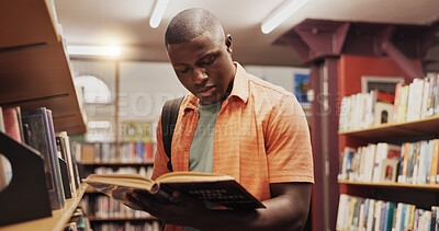 Buy stock photo Black man, reading and book as student in library for research, studying and exam preparation. Person, novel and literature information for knowledge, education and language assessment at university