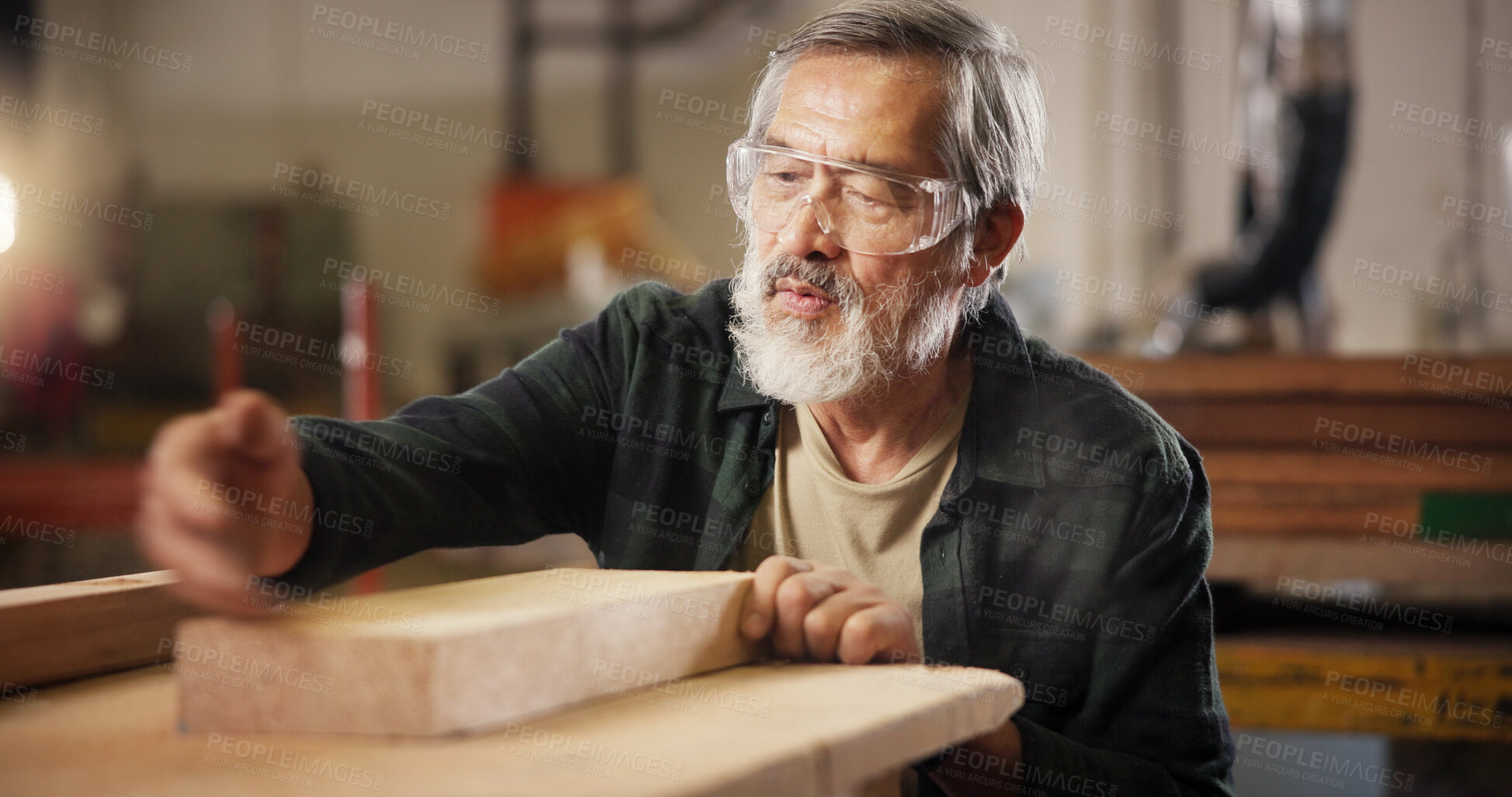 Buy stock photo Carpentry, measure and man with wood in workshop for furniture, building and lumber production. Construction, woodworking and mature carpenter for planks, timber and board for renovation in factory