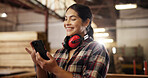 Smile, carpenter and woman with phone in workshop for inventory, furniture manufacturing or production. Woodwork, mobile or worker online for communication, order supply or joiner with project design