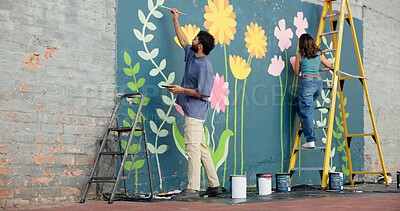 Buy stock photo Creative, couple and painting art on wall for project, mural design and renovation of community. Back, people and artist on ladder for improvement, diy decoration and makeover with flowers aesthetic