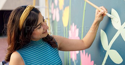 Buy stock photo Woman, smile and painting in city for mural art, creative wall and social responsibility to uplift community. Volunteer, creativity and outdoor with project for floral design, public service and DIY