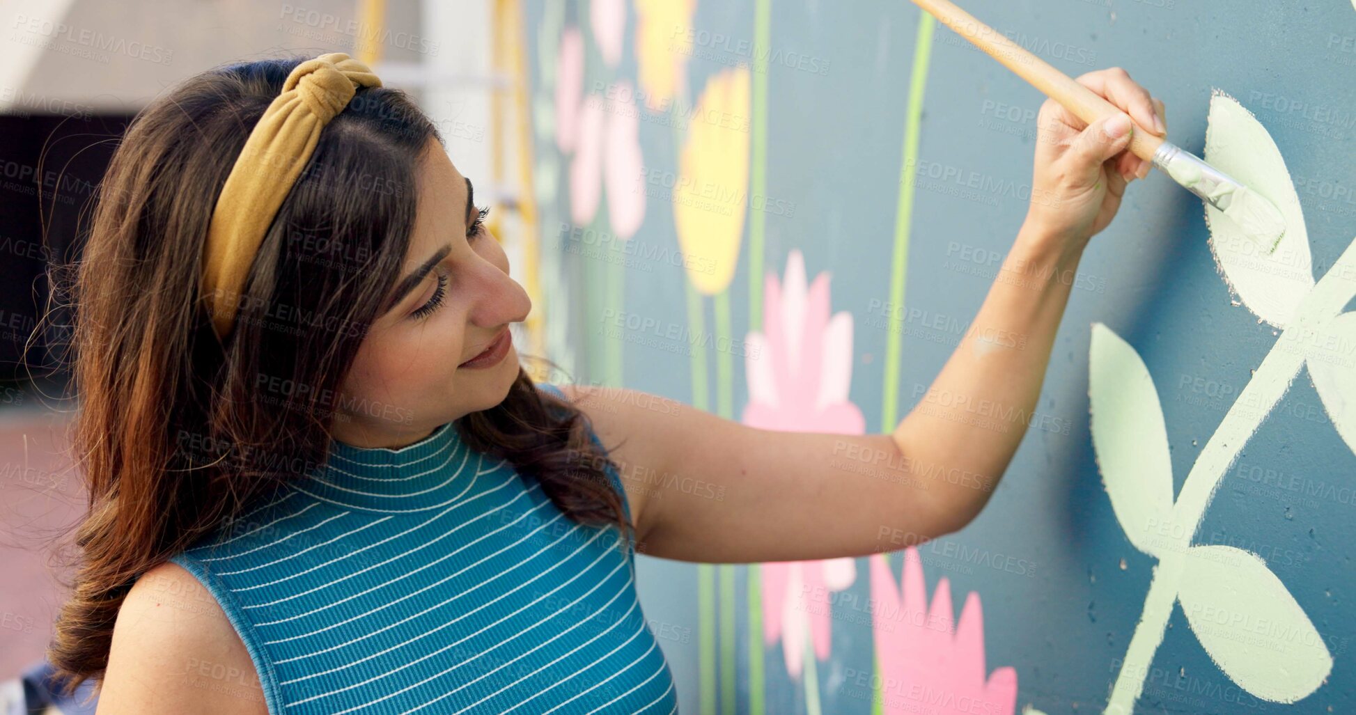 Buy stock photo Woman, smile and painting in city for mural art, creative wall and social responsibility to uplift community. Volunteer, creativity and outdoor with project for floral design, public service and DIY