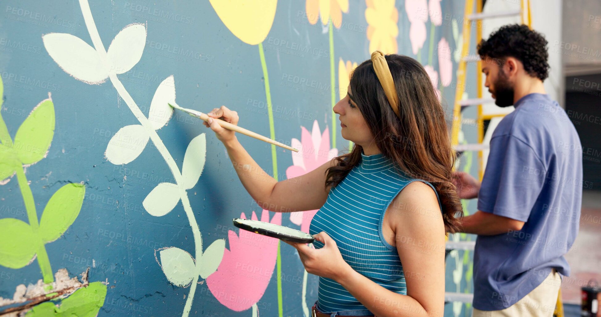 Buy stock photo People, creative and painting in city for wall art, mural and project to uplift community. Volunteer, team creativity and outdoor with equipment for floral design, designer collaboration or DIY hobby