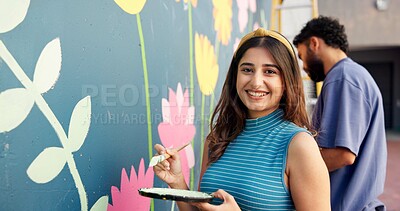 Buy stock photo Artist, woman and painting on wall for art project, mural design and community renovation. Portrait, couple and creative hobby for improvement process, DIY decoration and makeover of flower aesthetic