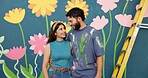 Mural, happy and couple by wall for art project, creative painting and decoration outdoors. Renovation, smile and man and woman hug with inspiration for flowers, aesthetic and diy design together