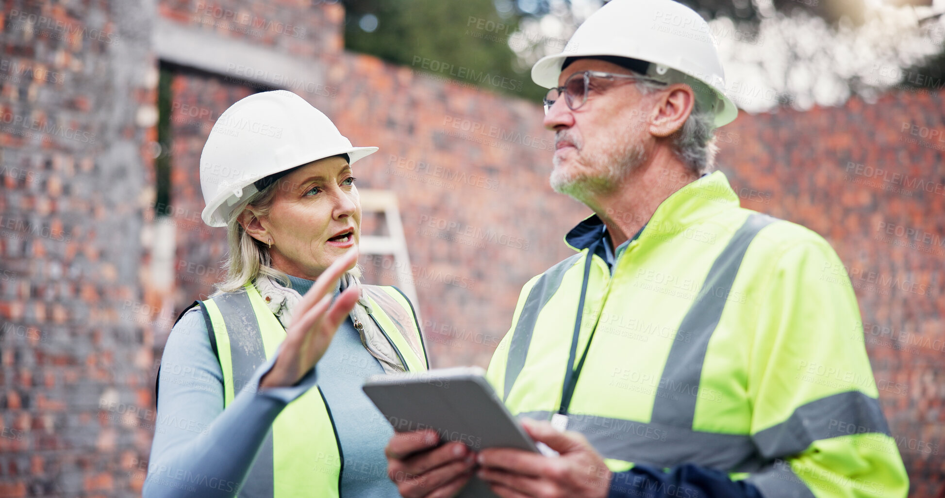 Buy stock photo Architecture, discussion and colleagues with tablet, outdoor and teamwork for project management and app. Construction, mature woman and man with tech for digital blueprint, collaboration and talking