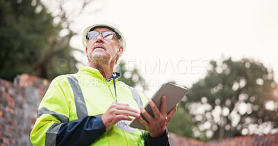 Buy stock photo Construction, mature man and tablet on site for project management, safety compliance or quality control. Engineer, worker and digital checklist for risk assessment, renovation progress or inspection