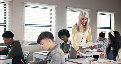 Buy stock photo Exam, high school and teacher in classroom with paper, test and assignment for education. Woman educator, teenage students and quiz notes in academy for learning, growth assessment and development