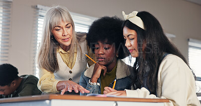 Buy stock photo School, university and teacher with students help for assessment, assignment and explain test question. College, academy and educator with girls for learning, teaching and education in classroom