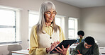 Teacher, tablet and happy in classroom at high school for curriculum information, course schedule or learning support. Educator, mature person and reading digital report for online education or study