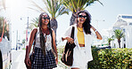 Walking, friends and women in street, funny and bonding together with laughing. Happy people, outdoor and travelling for shopping trip, reunion and sunglasses with joke, urban journey and humor