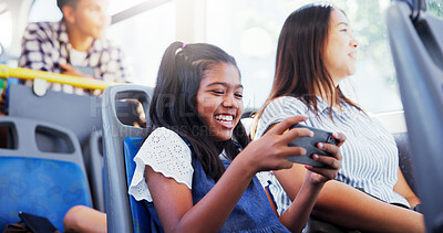 Buy stock photo Happy girl, child and watching with phone on bus for entertainment or online streaming in vehicle. Kid, traveler or smile with mobile smartphone in public transport for app or movie subscription